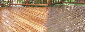A deck with wood stain and a white stripe.